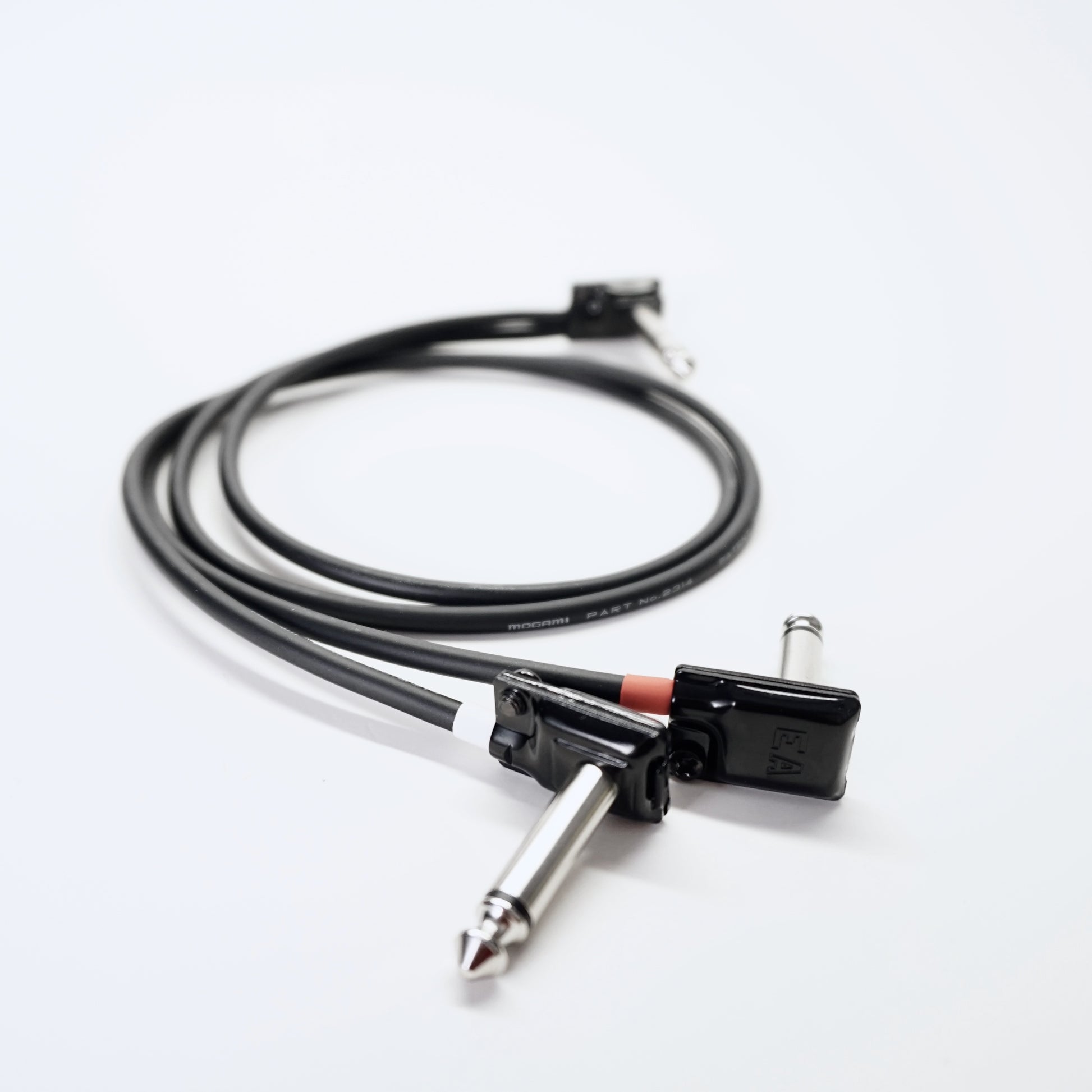 Guitar cable with plug on a white background