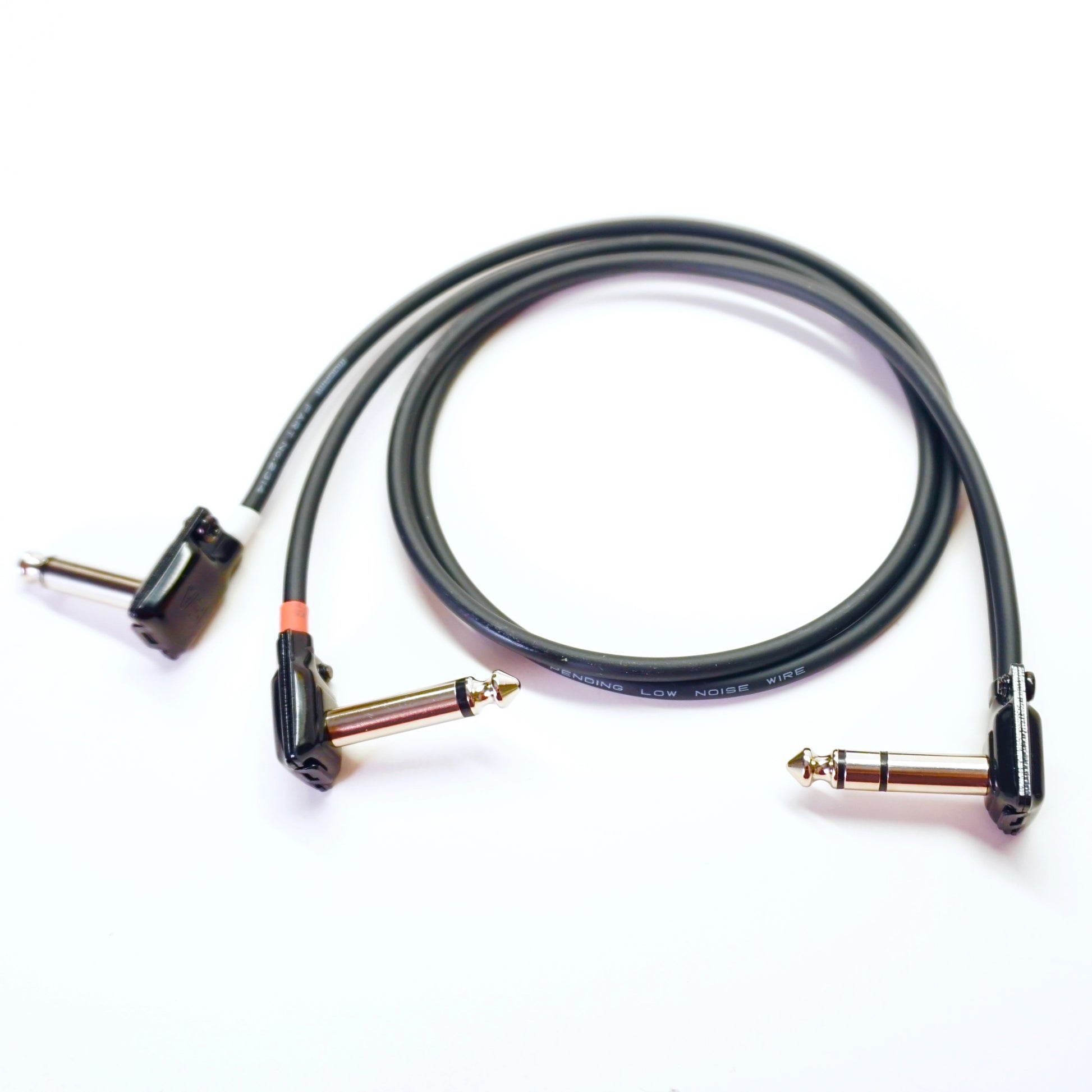 Black audio cable with two plug ends on a white background